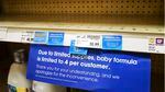 A "due to limited supplies" sign is shown on the baby formula shelf at a grocery store.