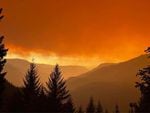 Smoke turns the morning light orange on Saturday in this photo taken near the Huckleberry Lookout, provided by the Cedar Creek Fire Incident Command.