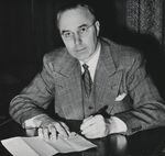 Oregon Governor Earl Snell signs a document in this historic photo.
