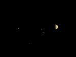 NASA's Juno spacecraft took this image in 2016 at a distance of 6.8 million miles from Jupiter. The planet's moons Io, Europa, Ganymede and Callisto are also visible.