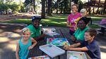 Shatoya Mills and Daylen Lawrence work with the summer meals program, where Carie Weisenbach-Folz and her three kids, Cody, Ada, and Linus Folz come for food and activities.
