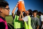 Jonathan Martinez drinks from the water cooler at McKay's boys soccer practice.