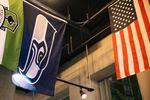 A Seattle Seahawks flag hangs next to an American flag at Red Bear Brewing.