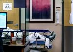 A patient waits for care in the hallway of the emergency department at Salem Health in Salem, Ore., Jan. 27, 2022, during the initial omicron surge.
