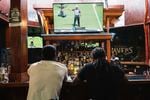 Football fans watch the Baltimore Ravens vs. New York Jets at the Hamilton Sports Bar and Grill in Baltimore on Sept. 18.