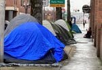 Multnomah County will receive a few million dollars less from state funding pledged earlier this year go help communities across Oregon get more people into housing and out of tents like these lining a street in Portland's Old Town in this March 23, 2022 file photo.