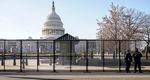 Capitol police officers stand outside of fencing that was installed around the exterior of the Capitol grounds, Thursday, Jan. 7, 2021 in Washington. The House and Senate certified the Democrat's electoral college win early Thursday after a violent throng of pro-Trump rioters spent hours Wednesday running rampant through the Capitol. A woman was fatally shot, windows were bashed and the mob forced shaken lawmakers and aides to flee the building, shielded by Capitol Police.