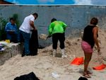 People fill sandbags in West Miami in 2019 in preparation for Hurricane Dorian. South Florida is home to millions of Latino people, and is at increasing risk for floods from sea level rise and more powerful hurricanes due to climate change.