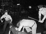 A New York City police officer grabs a youth by the hair as another officer clubs a young man during a confrontation in Greenwich Village after a Gay Power march in New York on Aug. 31, 1970. A police raid at the Stonewall Inn in 1969 set off the modern gay rights movement.