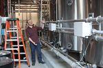 Ryan Reid with Deschutes Brewery shows off one of the brew kettles at the flagship brewery in Bend. 