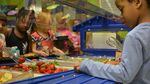 Students at Rigler School select their daily required servings of fruits and veggies from a salad bar.