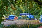 Camping along the 2300 block of Southwest Naito Parkway in Portland last year.  It was the site of the second of now six "Safe Rest Villages" in the city.