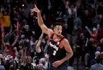 Portland Trail Blazers guard CJ McCollum reacts after hitting a shot late in the second half of the team's NBA basketball game against the Chicago Bulls in Portland, Ore., Wednesday, Nov. 17, 2021. The Blazers won 112-107.