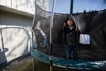 Romeo, 7, left, and his brother Rey play on the trampoline in the backyard of their family home in Vancouver, Wash., Saturday, March 2, 2019.