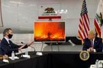 President Donald Trump listens as California Gov. Gavin Newsom speaks during a briefing at Sacramento McClellan Airport, in McClellan Park, Calif., Monday, Sept. 14, 2020, on the western wildfires.