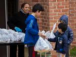 Children collect their free meal at East Silver Spring Elementary School.